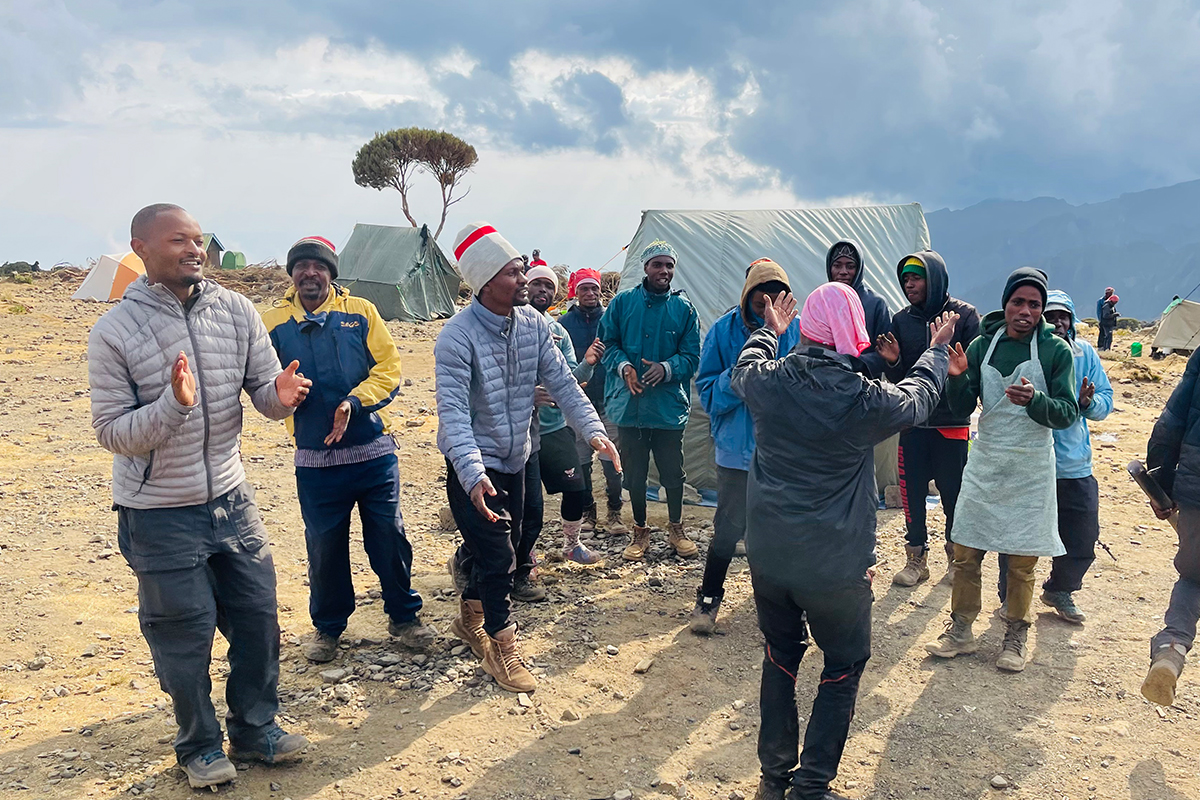 People dancing and enjoying while on Kilimanjaro Summit